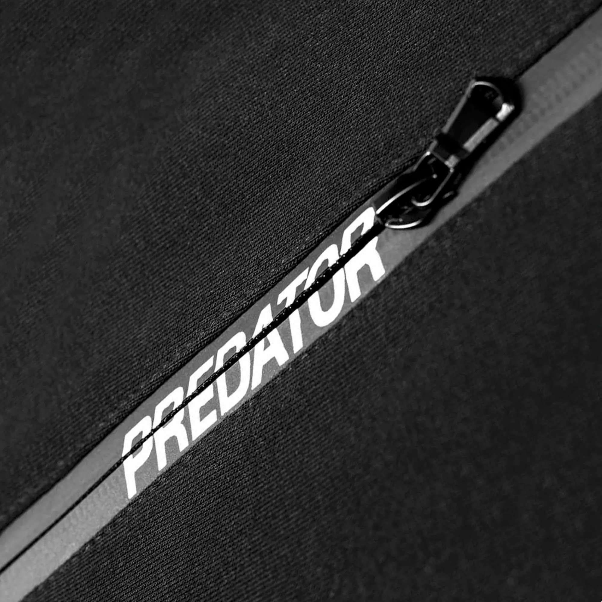 Black Polo Shirt Close-up of Predator Branding in Zipper